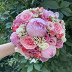 Wedding bouquet with peonies, roses and lisianthus