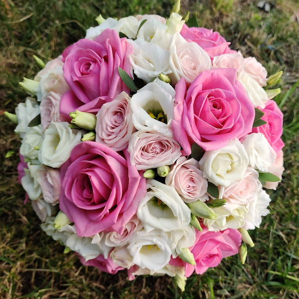 Wedding bouquet of pink roses and lisianthus