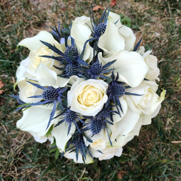 Bridal bouquet of roses, eryngium and calla