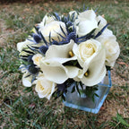 Bridal bouquet of roses, eryngium and calla