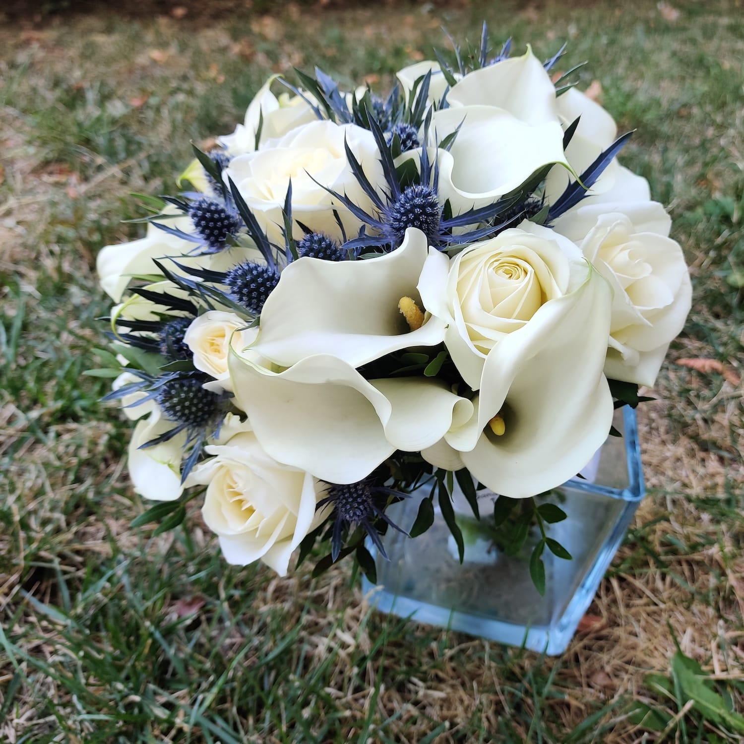 Bridal bouquet of roses, eryngium and calla