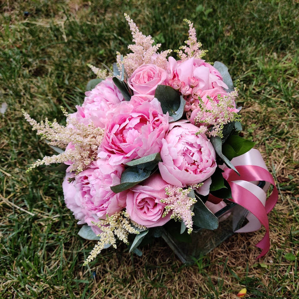 Bridal bouquet of peonies, astilbe and pink roses