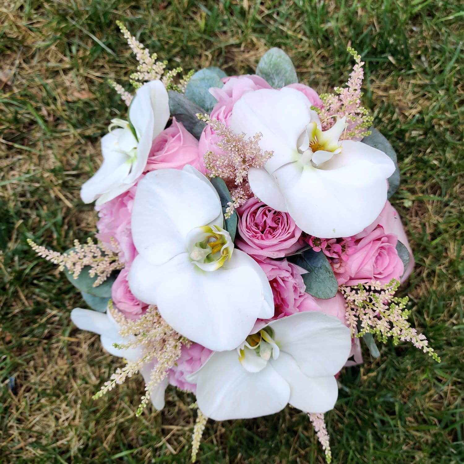 Bridal bouquet of pink peonies and orchids