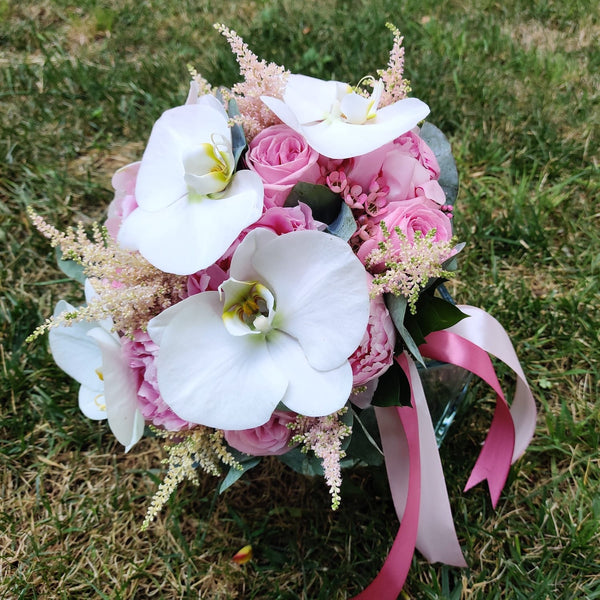 Bridal bouquet of pink peonies and orchids