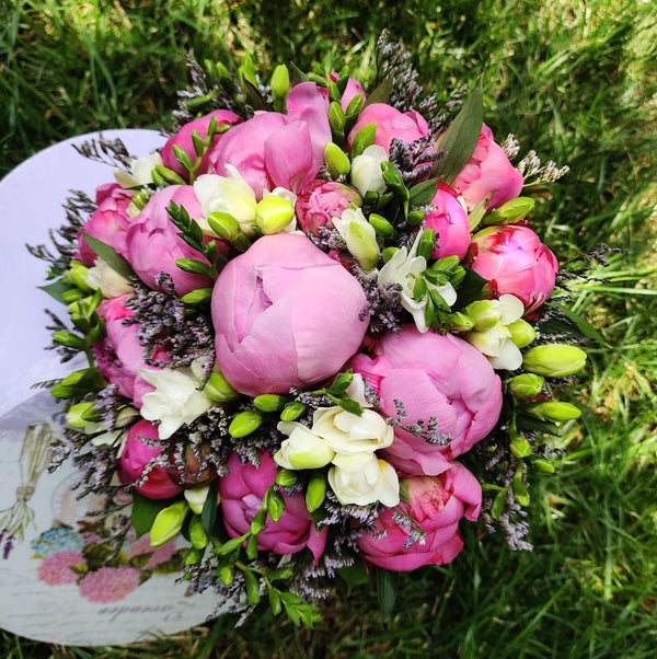 Elegant bridal bouquet with peonies and freesias