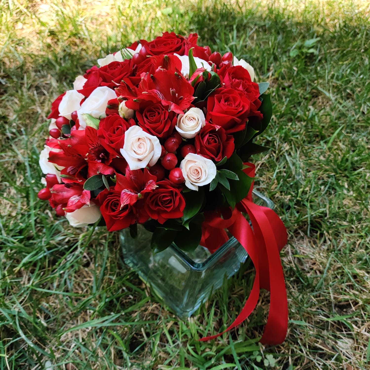 Red bridal bouquet with mini roses and hypericum