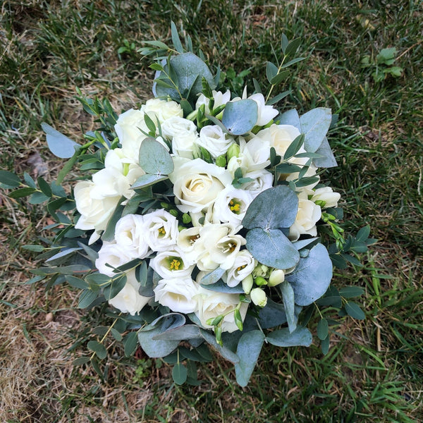 Bridal bouquet of roses and white lisianthus