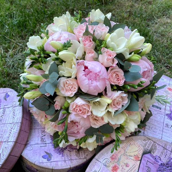 Bridal bouquet with peonies, freesias and mini roses