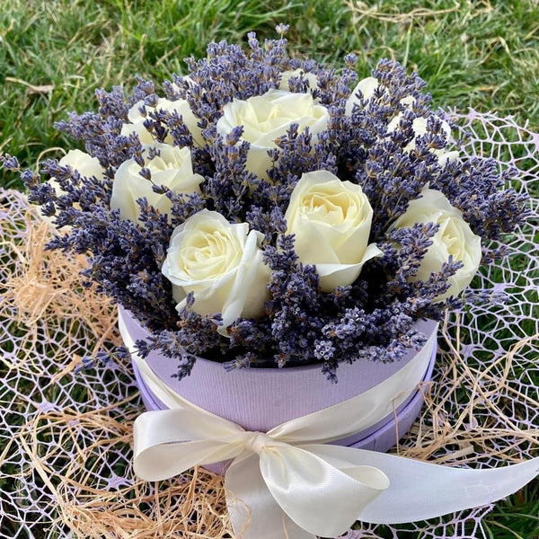 White roses and lavender in a round box